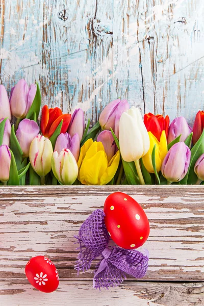 Colorful tulips on wooden table. — Stock Photo, Image