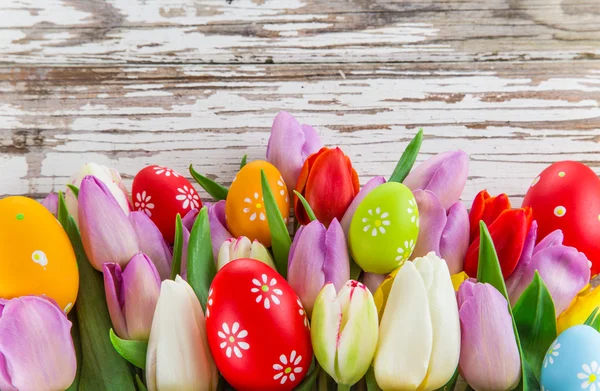 Colorful tulips on wooden table. — Stock Photo, Image