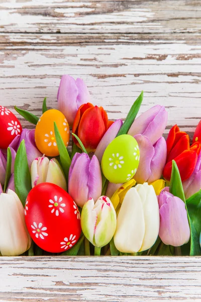 Colorful tulips on wooden table. — Stock Photo, Image