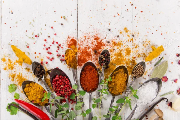 Various colorful spices on wooden table — Stock Photo, Image