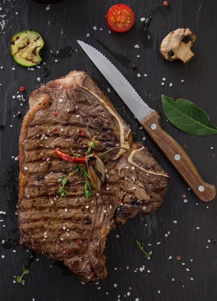 Delicious beef steak on black stone table. — Stock Photo, Image