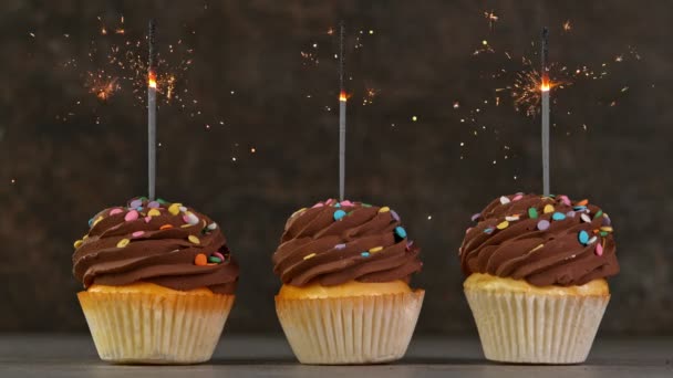 Cupcake al cioccolato con scintille ardenti su sfondo pietra scura. Super rallentatore. — Video Stock