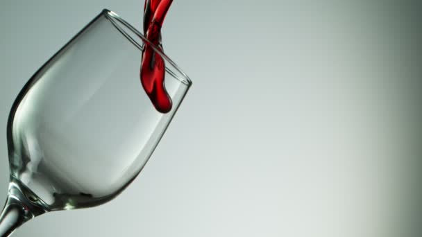 Super Slow Motion Detail Shot of Pouring Red Wine from Bottle on dark Background. — Stock Video