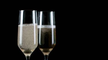 Altın Bokeh 'in arka planında köpüklü şampanya kadehleri.