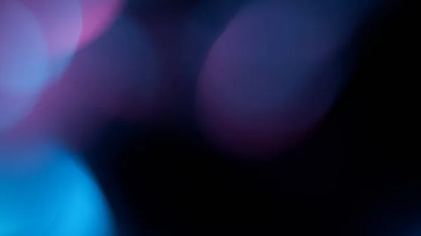 Abstraktní světlomety Bokeh, světlice objektivu, rozostřené zářivé barevné neonové paprsky — Stock fotografie