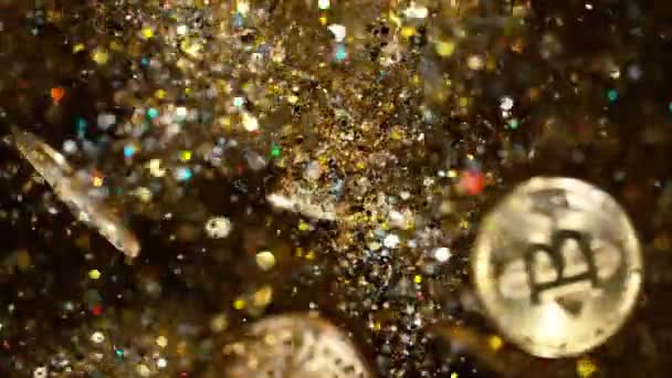 Cryptocurrencies Bitcoins flying with gold shiny glitters. — Stock Video