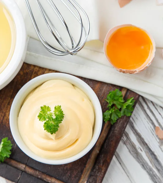 Bowl of Mayonnaise sauce on white wooden table — Stock Photo, Image