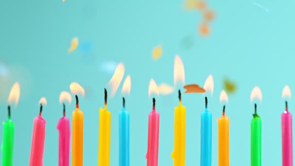 Τούρτα γενεθλίων με καύση πολύχρωμα κεριά σε μπλε φόντο παστέλ. — Αρχείο Βίντεο