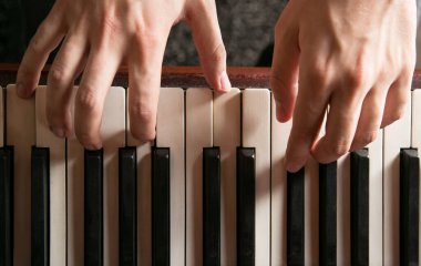 Close-up of hands playing the piano clipart