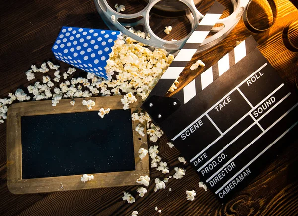 Cinema concept of vintage film reels, clapperboard and other tools — Stock Photo, Image