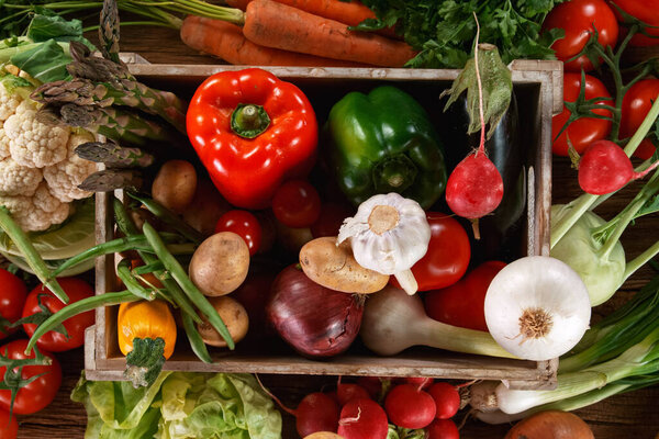 Fresh organic vegetables in a wooden box.