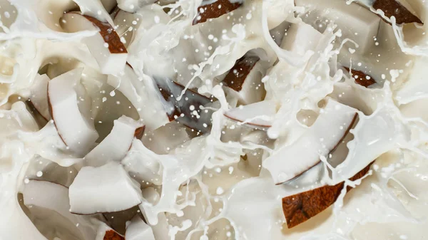 Throwing of coconut pieces into milk — Stock Photo, Image