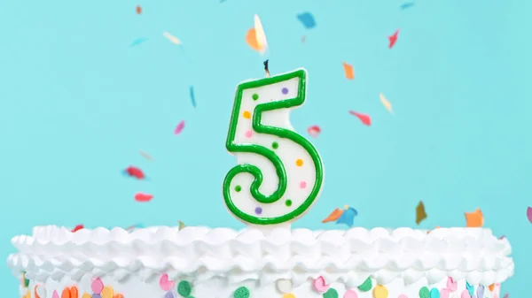 Colorful tasty birthday cake with candles shaped like the number 5. — Stock Photo, Image