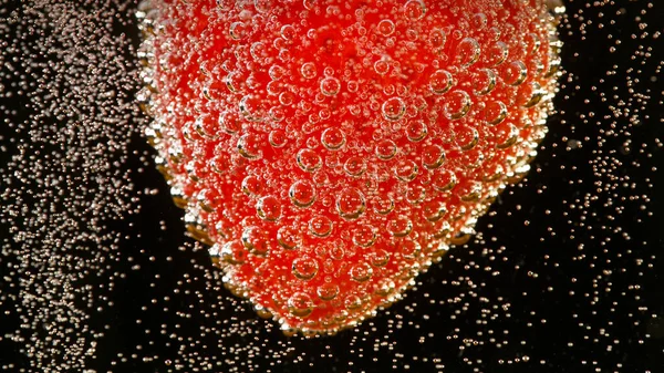 Super slow motion of strawberry falling into champagne — Stock Photo, Image