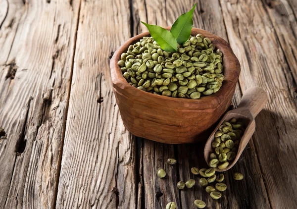 Green coffee beans in wooden bowl — Stock Photo, Image