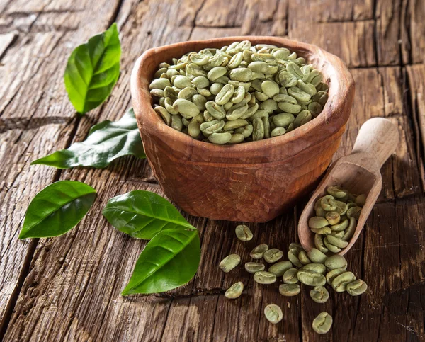 Grüne Kaffeebohnen in Holzschale — Stockfoto