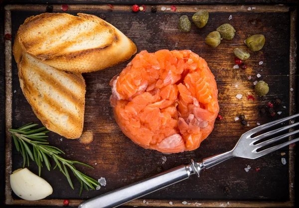 Salmon steak on wooden table — Stock Photo, Image