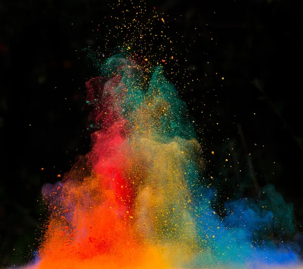 Launched colorful powder over black — Stock Photo, Image