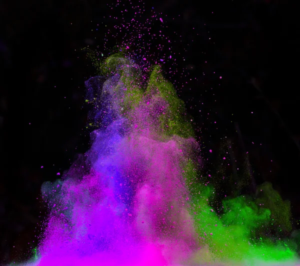 Launched colorful powder over black — Stock Photo, Image