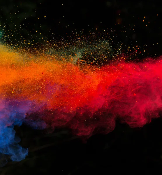 Launched colorful powder over black — Stock Photo, Image