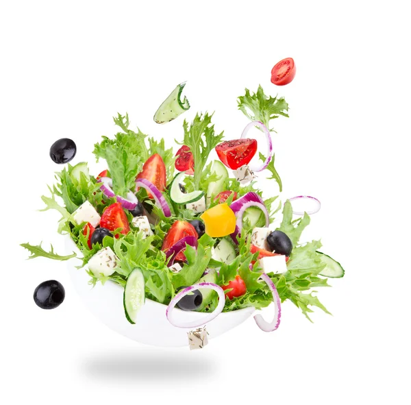 Fresh salad with flying vegetables ingredients Stock Picture