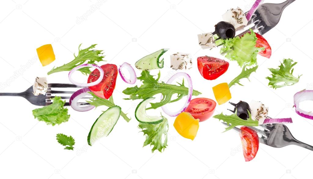 Fresh salad with flying vegetables ingredients