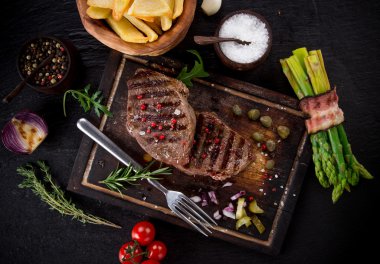 Beef steak on stone table clipart