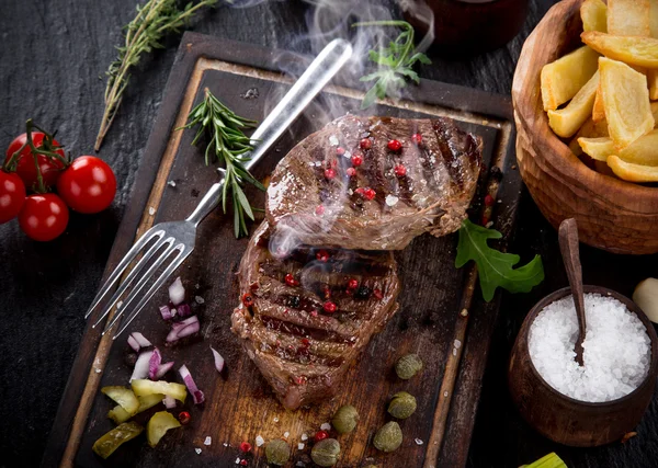 Beef steak on stone table — Stock Photo, Image