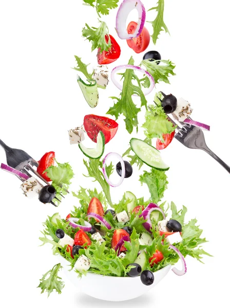 Fresh salad with flying vegetables ingredients — Stock Photo, Image