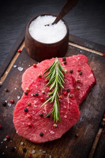 Raw beef steak on wooden table — Stock Photo, Image