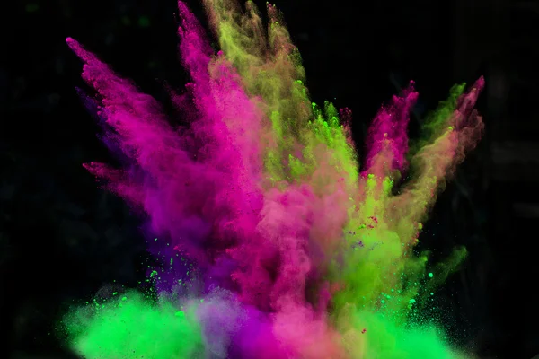 Launched colorful powder over black — Stock Photo, Image