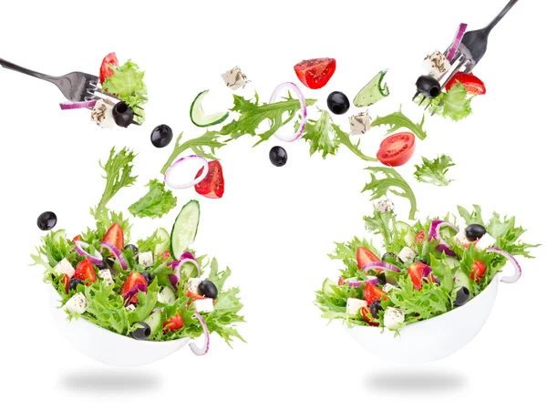 Fresh salad with flying vegetables ingredients — Stock Photo, Image