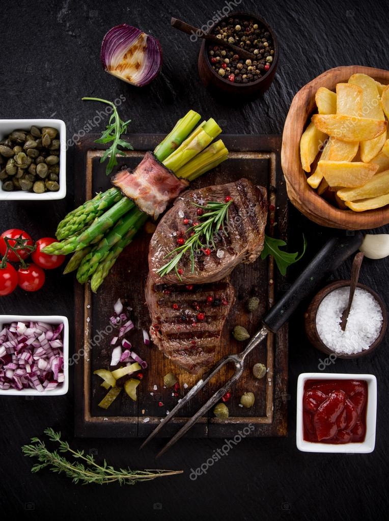 Beef steak on wooden table Stock Photo by ©Kesu01 55566789