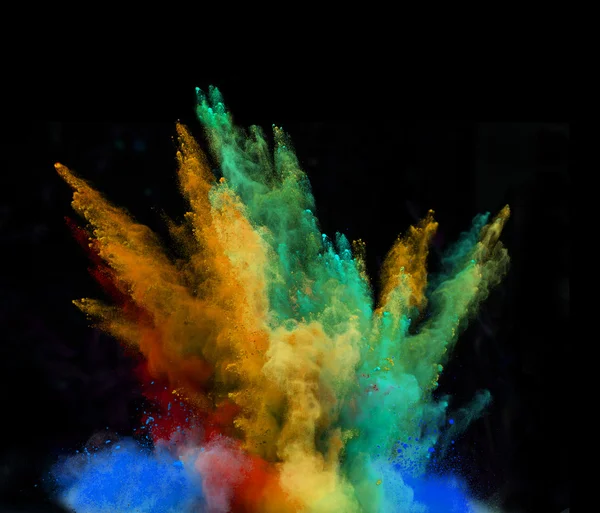 Launched colorful powder over black — Stock Photo, Image