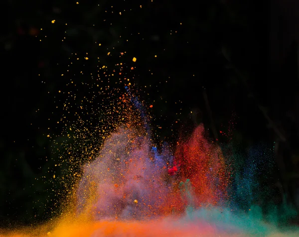 Launched colorful powder over black — Stock Photo, Image