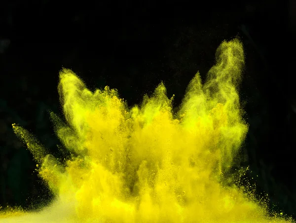 Launched colorful powder over black — Stock Photo, Image