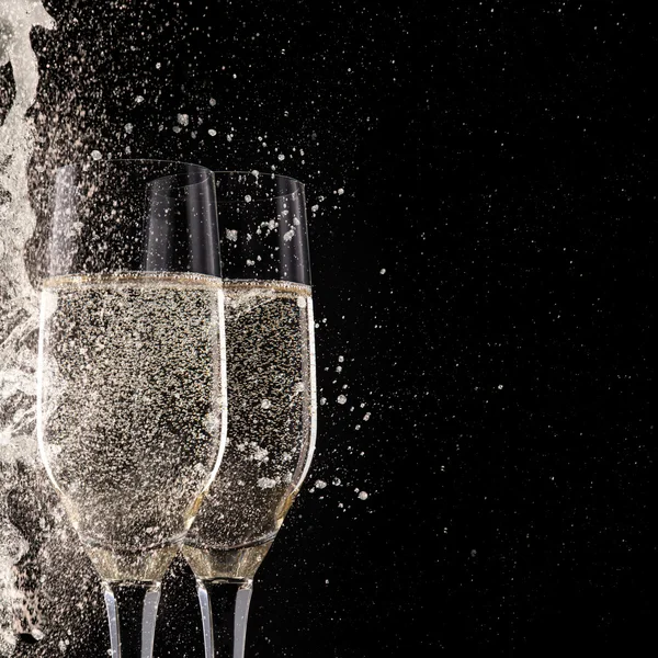 Champagne flutes on black background — Stock Photo, Image