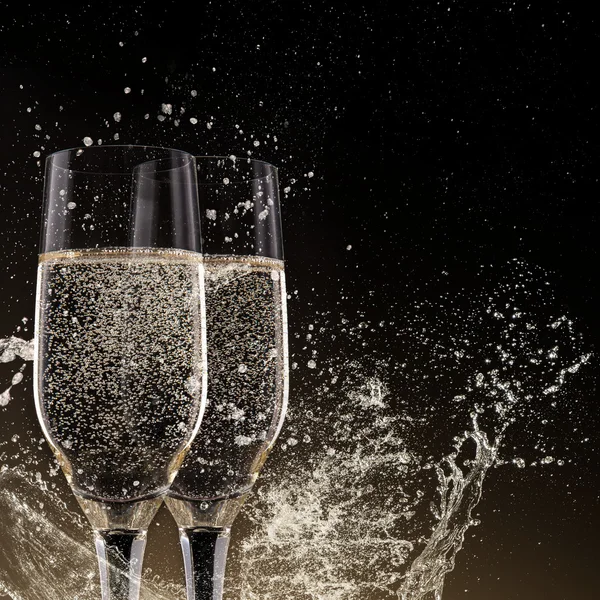 Champagne flutes on black background — Stock Photo, Image