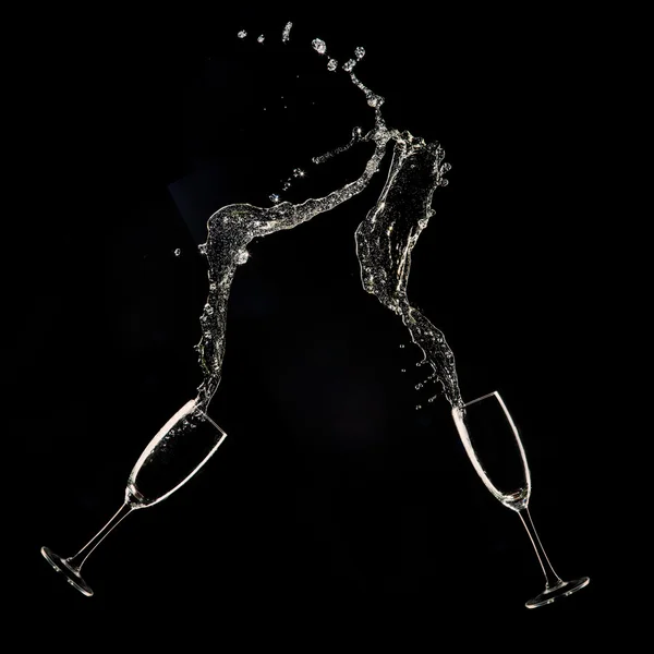 Champagne flutes on black background