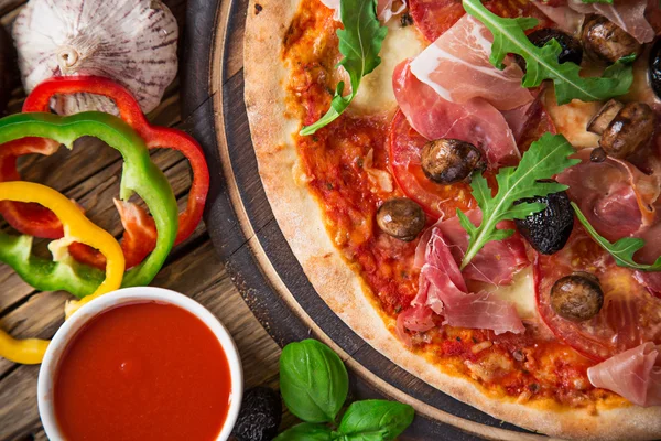 Delicious italian pizza served on wooden table — Stock Photo, Image