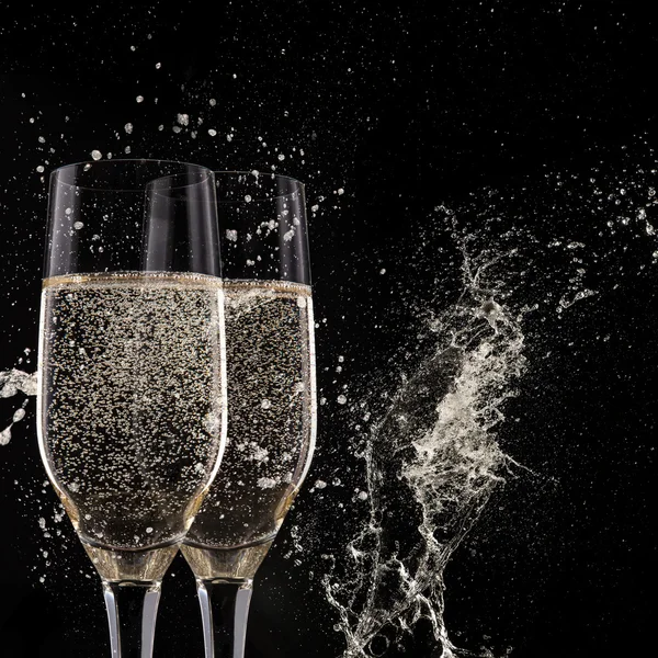 Champagne flutes on black background — Stock Photo, Image