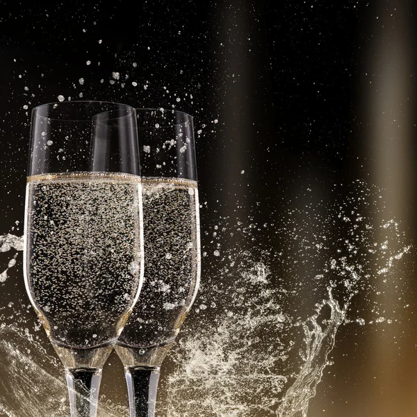 Champagne flutes on black background — Stock Photo, Image