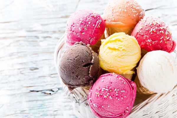 Ice cream scoops on wooden table. — Stock Photo, Image