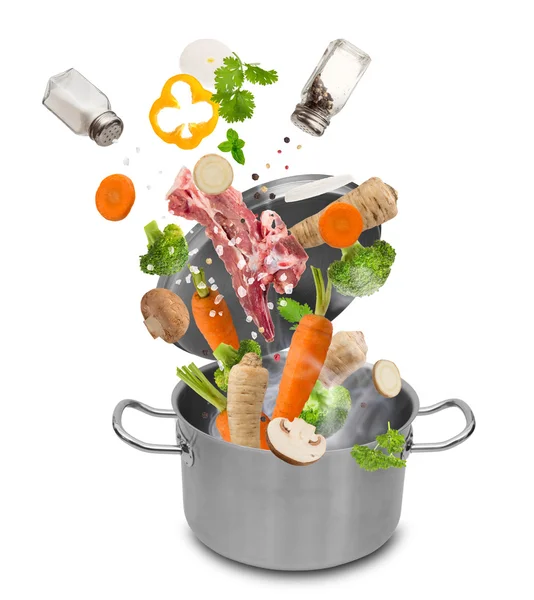 Fresh vegetables falling into stainless steel pot — Stock Photo, Image