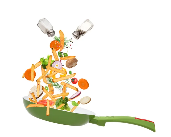 Pan with vegetables in freeze motion — Stock Photo, Image