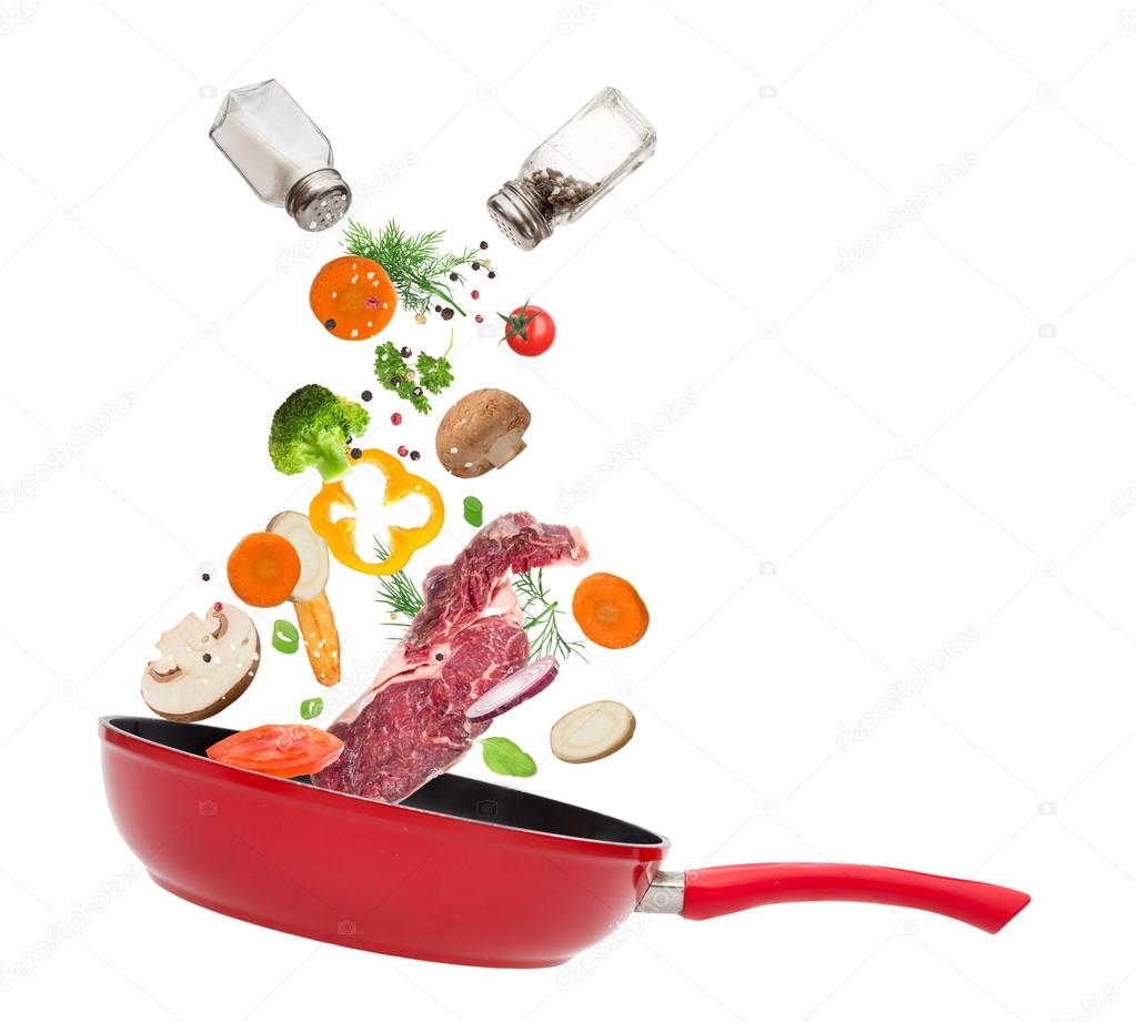Pan with vegetables in freeze motion