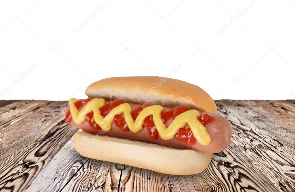 Hot dog on wooden table.