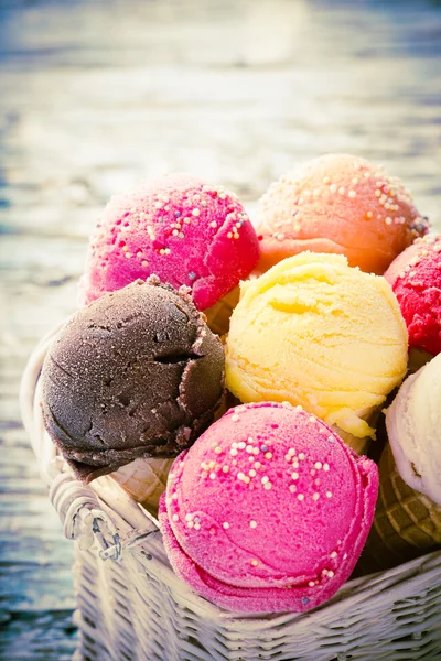 Ice cream scoops on wooden table. — Stock Photo, Image