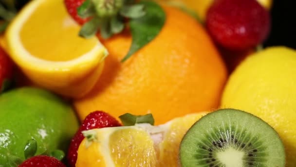 Fresh fruits on black background. — Stock Video