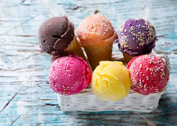 Ice cream scoops on wooden table. — Stock Photo, Image